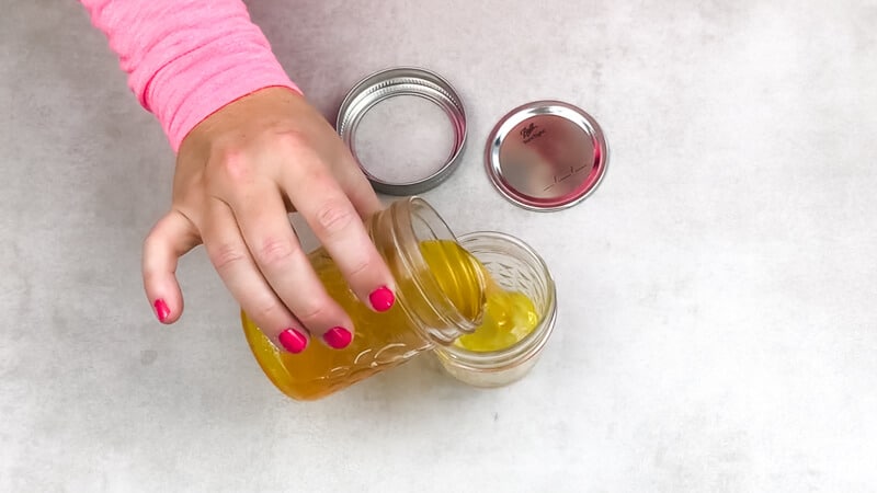 pouring shea butter into containers 