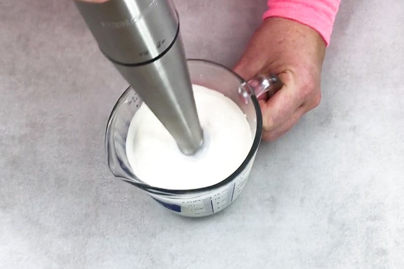 beating together ingredients to make homemade body butter 