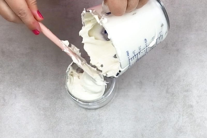 adding the whipped body butter into jars 