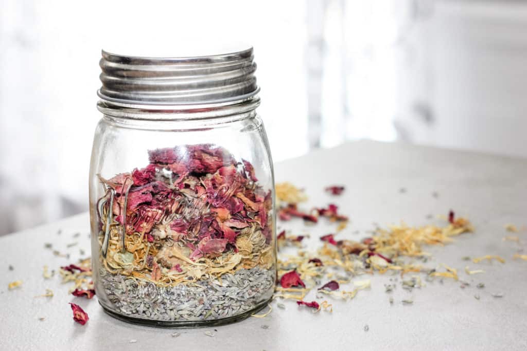How to Quickly Make Herbal Infused Carrier Oils: Rose, Lavender and Calendula herbs being infused in a jar of carrier oil.